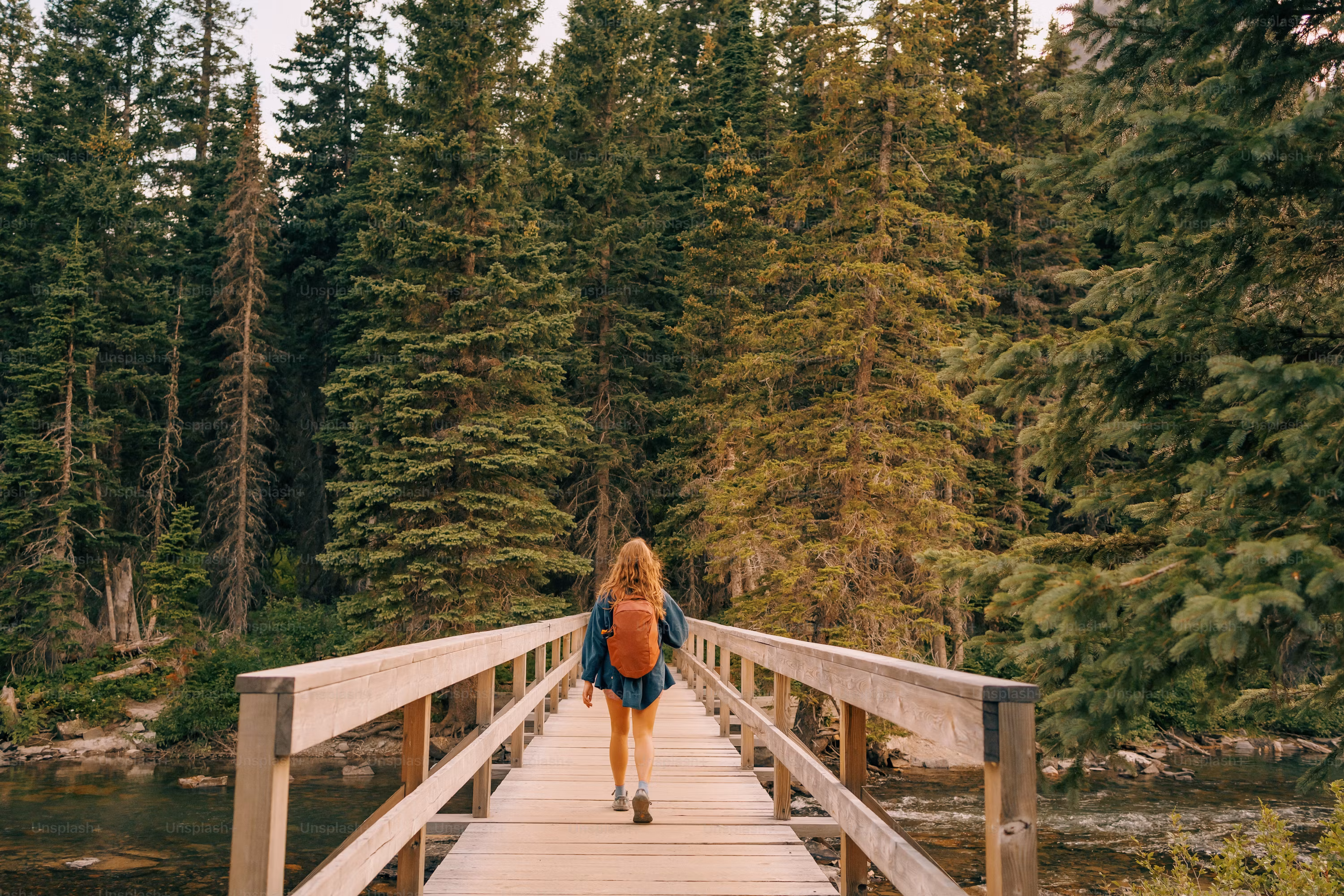 Individual walking outdoors along a scenic trail